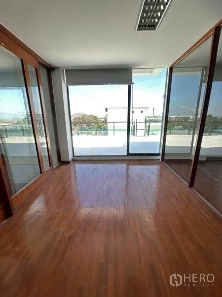 Home Office for rent or sale in Bang Phli, Samut Prakan - Compact office with floor-to-ceiling windows opening to a terrace and district views.