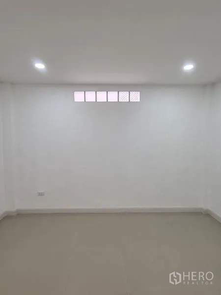 ทาวน์เฮาส์ ให้เช่าในKhlong Toei, Bangkok - ห้องโล่งผนังสีขาว พื้นกระเบื้อง และช่องแสงแนวนอนด้านบน