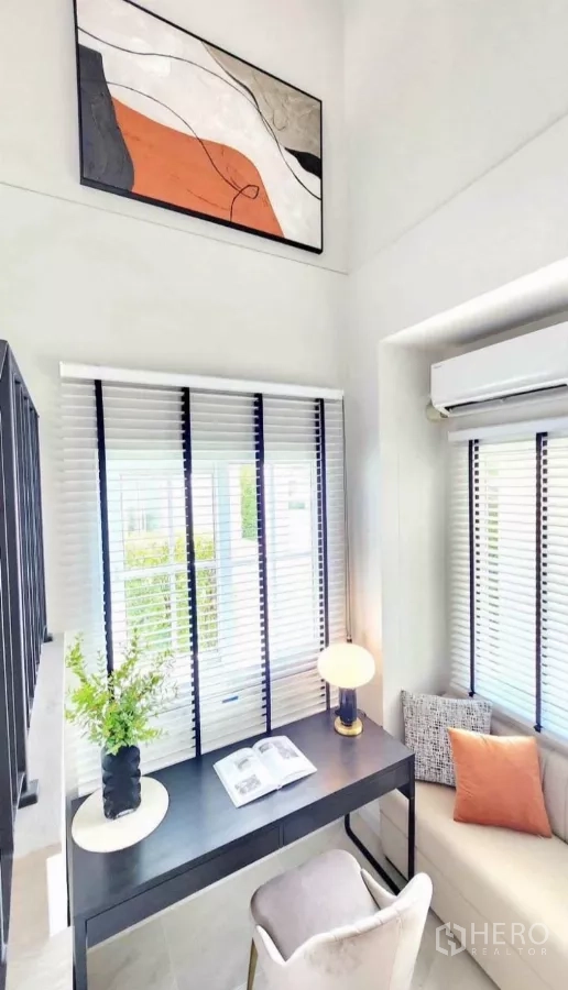 Detached House for rent in Bang Phli, Samut Prakan - Light-filled corner workstation with artwork and window seating.