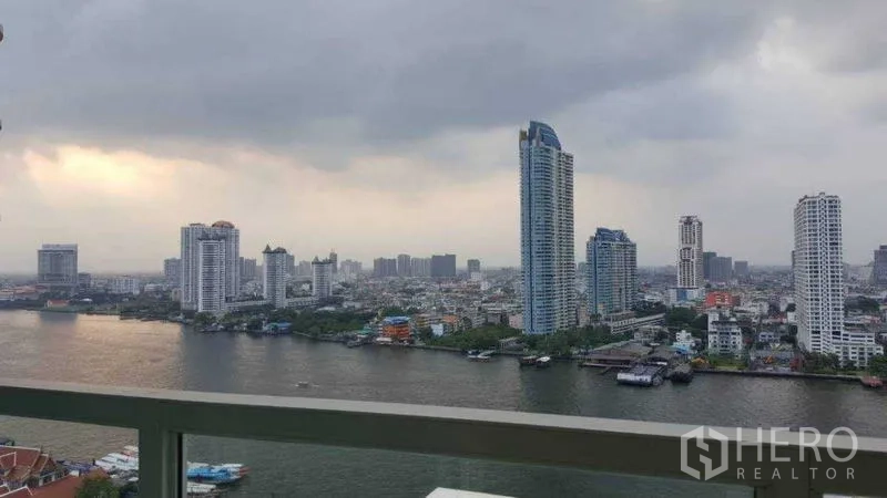 Condominium for rent in Bang Kho Laem, Bangkok - Balcony perspective of the Chao Phraya River and high-rise skyline.