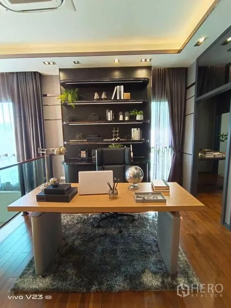 Detached House for sale in Wang Thonglang, Bangkok - Loft-style home office with desk, built-in shelving and floor-to-ceiling curtains.