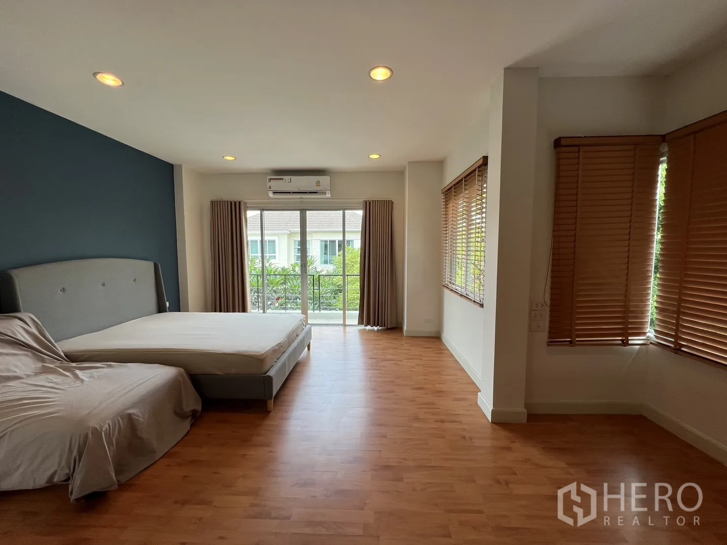 独立式住宅 出租在Saphan Sung, Bangkok - 采光良好的卧室，木地板、窗户和空调