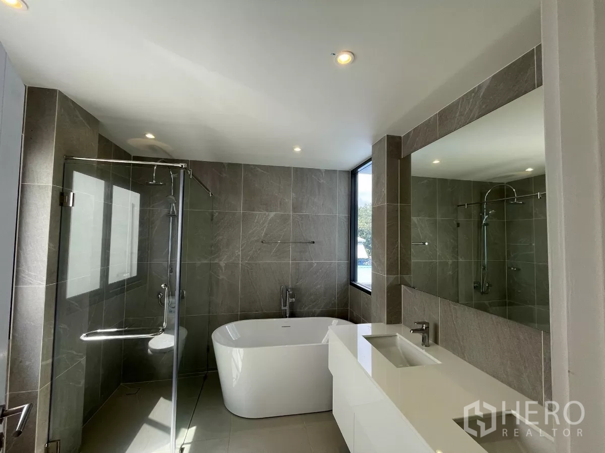 Home Office for rent in Don Mueang, Bangkok - Contemporary bathroom with freestanding tub, glass shower and long vanity.