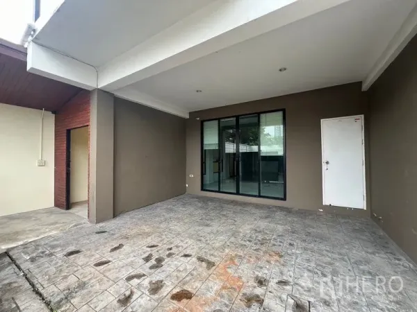 ทาวน์เฮาส์ ให้เช่าหรือขายในKhlong Toei, Bangkok - โรงจอดรถมีหลังคาพร้อมพื้นคอนกรีตพิมพ์ลาย ประตูกระจกบานเลื่อนและประตูเก็บของด้านข้าง