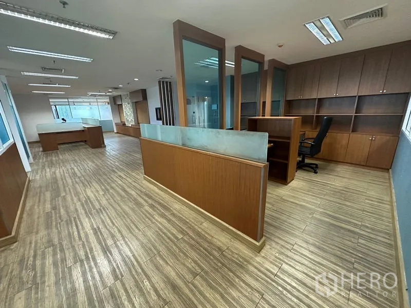 Office Space for rent or sale - Long open workspace with cubicles and extensive built-in storage.
