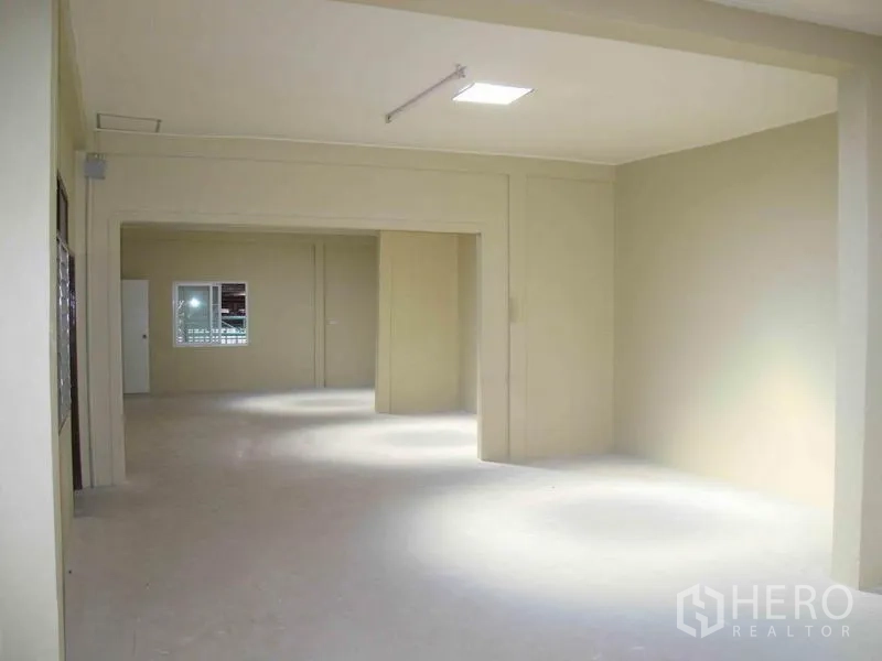 Warehouse for rent in Wang Thonglang, Bangkok - Bright partitioned office or workspace inside the warehouse with windows and overhead lighting.