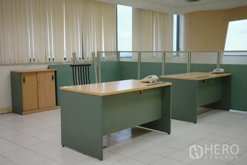 Office Space for rent in Bang Na, Bangkok - Bright corner office zone with desks, partitions and vertical blinds on the windows.