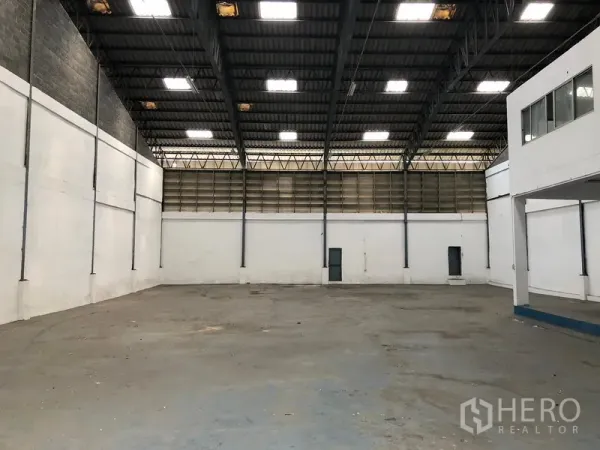 คลังสินค้า ให้เช่าในBang Phli, Samut Prakan - พื้นโกดังโล่ง โปร่งเพดานสูง แผ่นหลังคาโปร่งแสง และประตูทางเข้าออกด้านข้าง