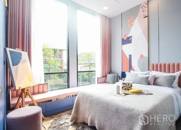 Detached House for rent or sale in Prawet, Bangkok - Sunlit bedroom with large windows, pastel curtains and contemporary artwork.