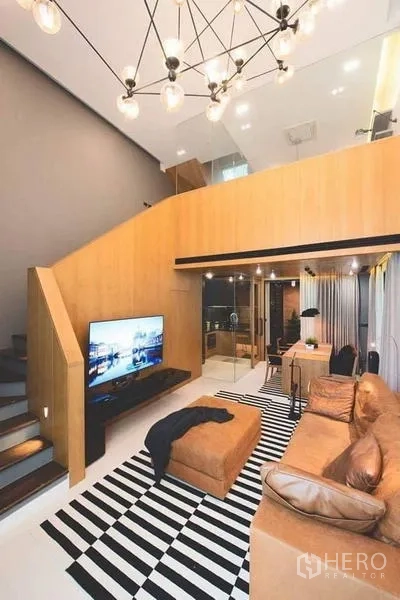 Townhouse for sale in Lak Si, Bangkok - Sleek kitchen beside a dining area with pendant lights and glass partition.