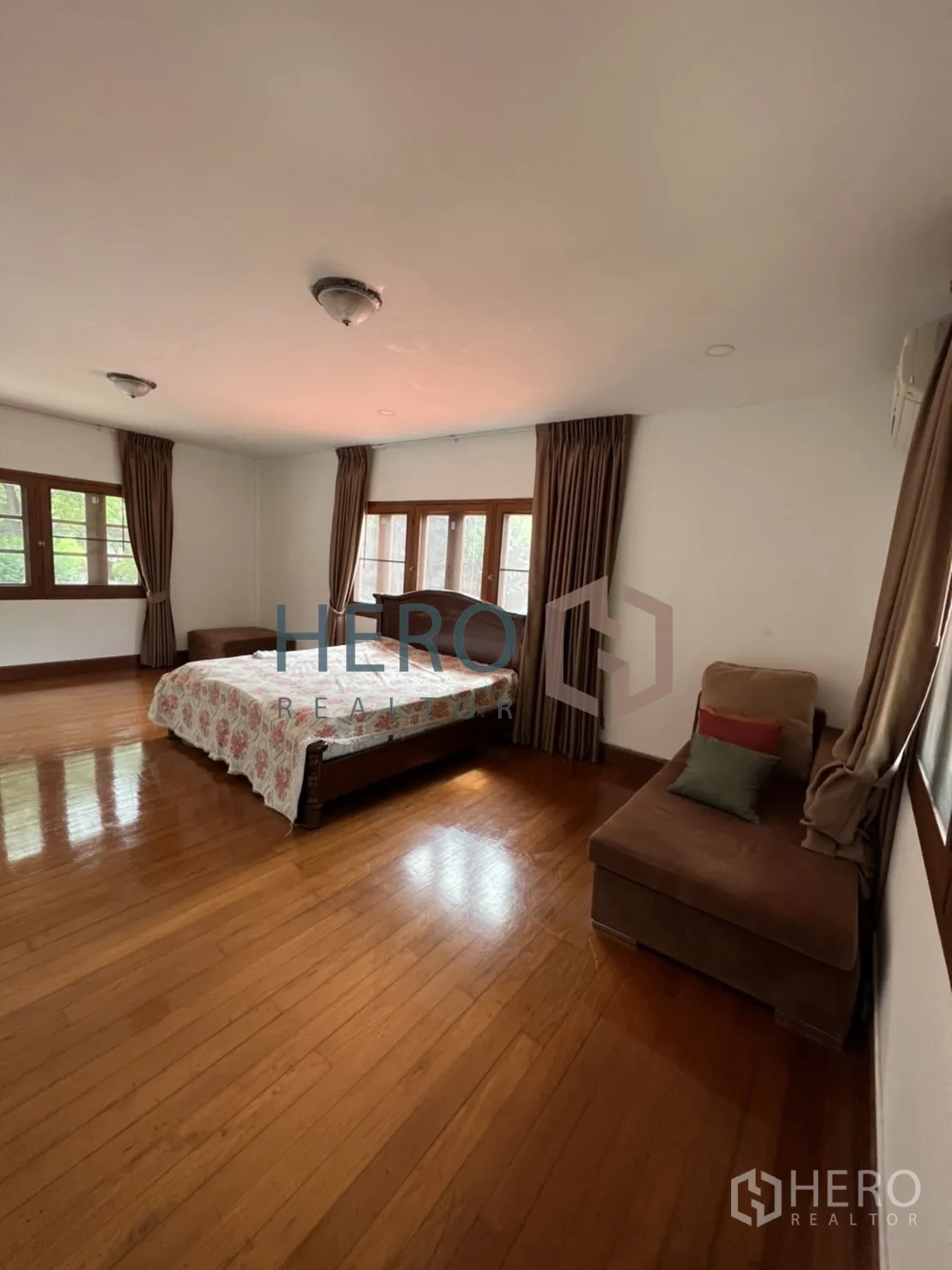 独立式住宅 出租在Watthana, Bangkok - 大卧室，摆放床与转角沙发，采光良好