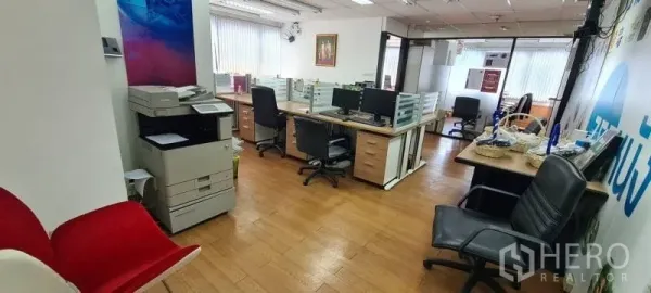 Office Space for rent in Watthana, Bangkok - Fitted office interior showing copier station, workstations with dividers, wood floors, and natural light.