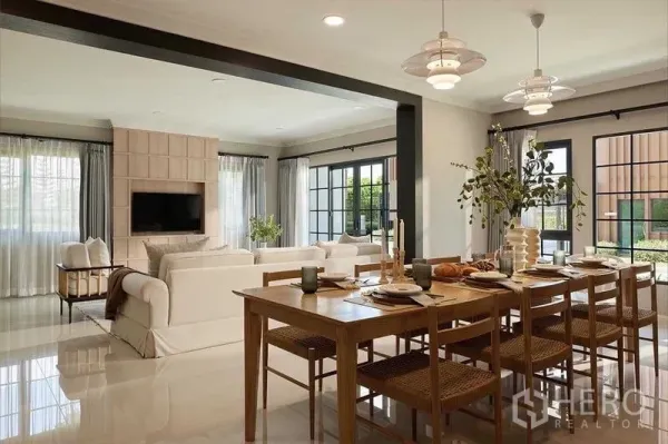 Detached House for sale in Bang Phli, Samut Prakan - Open-plan dining and living area with wooden table, pendant lights and large windows to the garden.