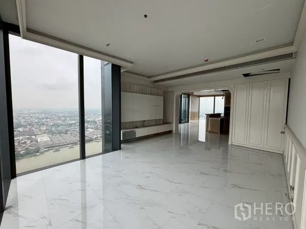 Condominium for sale in Bang Kho Laem, Bangkok - Duplex penthouse living room with marble floors, floor-to-ceiling windows and sweeping Chao Phraya River view.