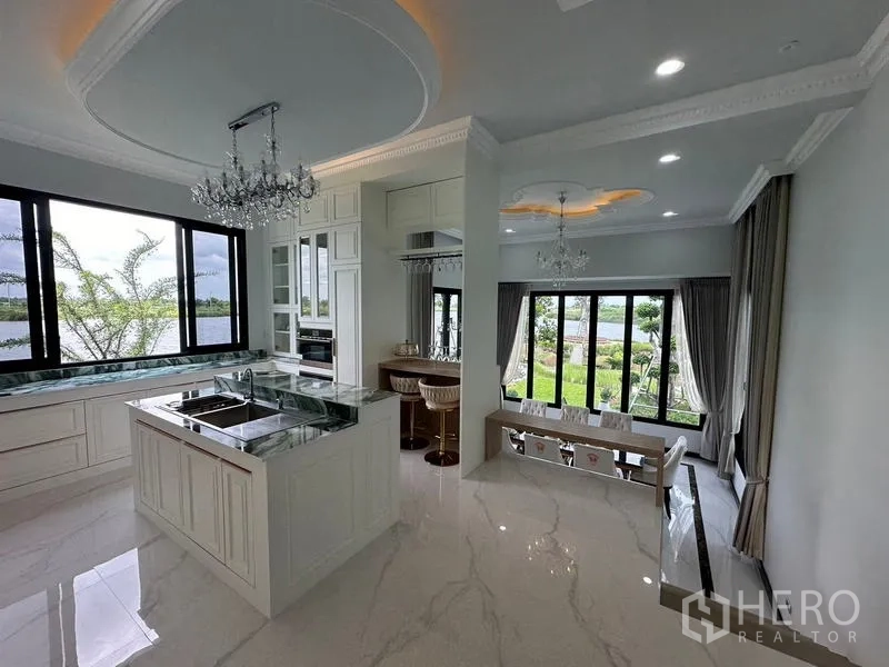 Detached House for sale in Sai Noi, Nonthaburi - Bright European-style kitchen with marble island opening to dining room and lake views.