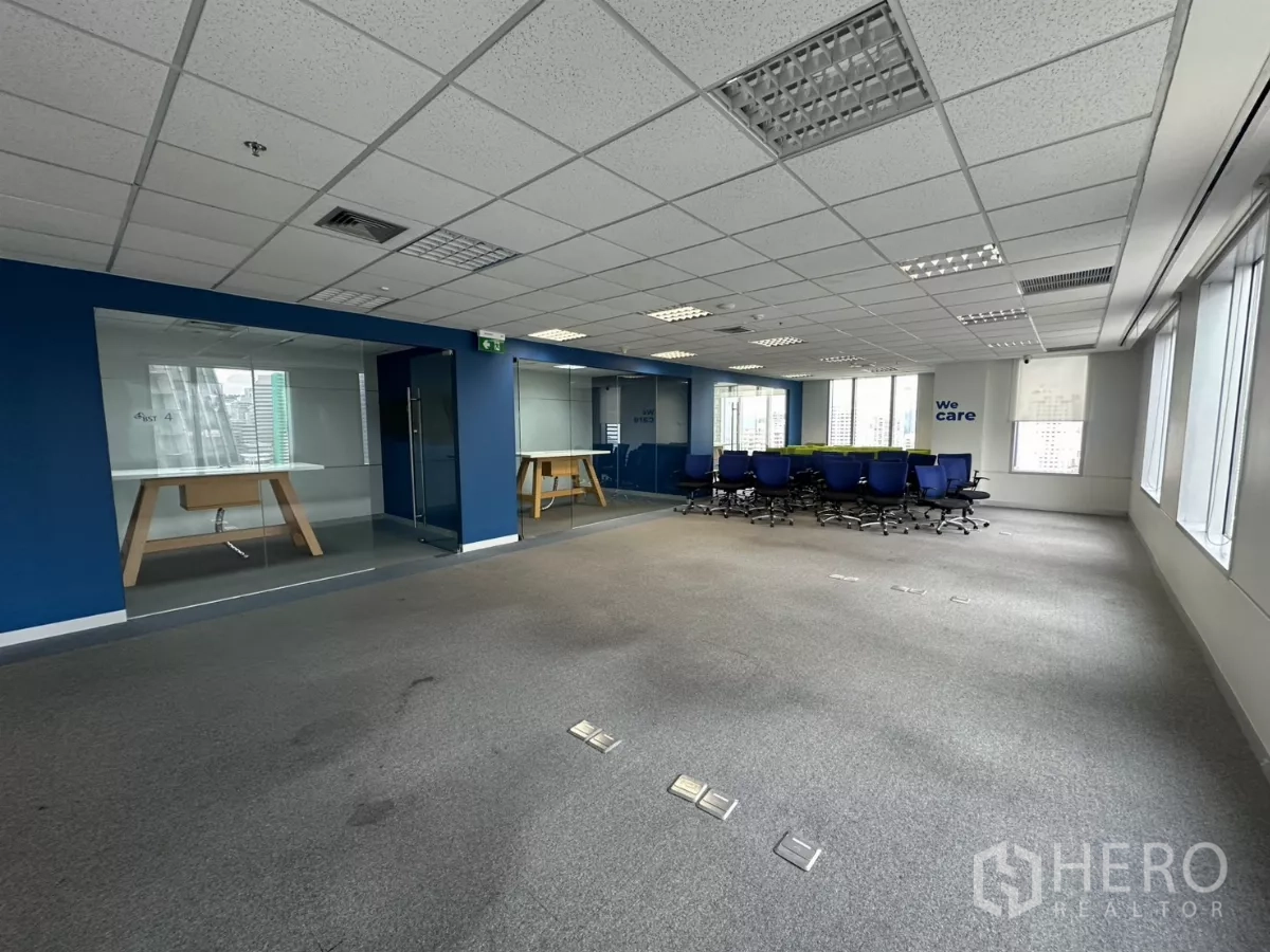 办公空间 出租在Watthana, Bangkok - 开放楼层，玻璃房与标注“We care”的会议区。