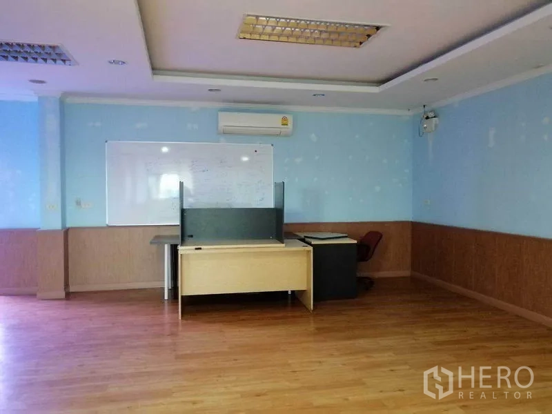 Office Space for rent in Bueng Kum, Bangkok - Meeting room with a whiteboard, laminate flooring, and ceiling lights.