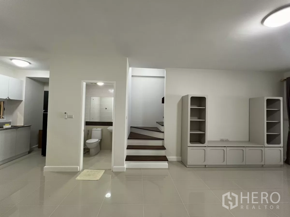 Townhouse for rent in Bang Kapi, Bangkok - Ground floor with staircase and guest bathroom visible.