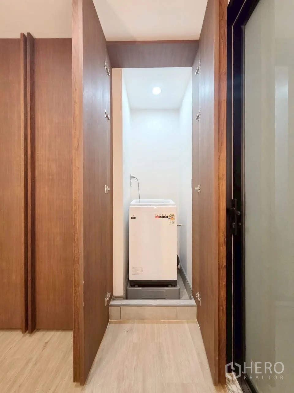 Condominium for rent in Sathon, Bangkok - Concealed laundry closet with a top-load washing machine.