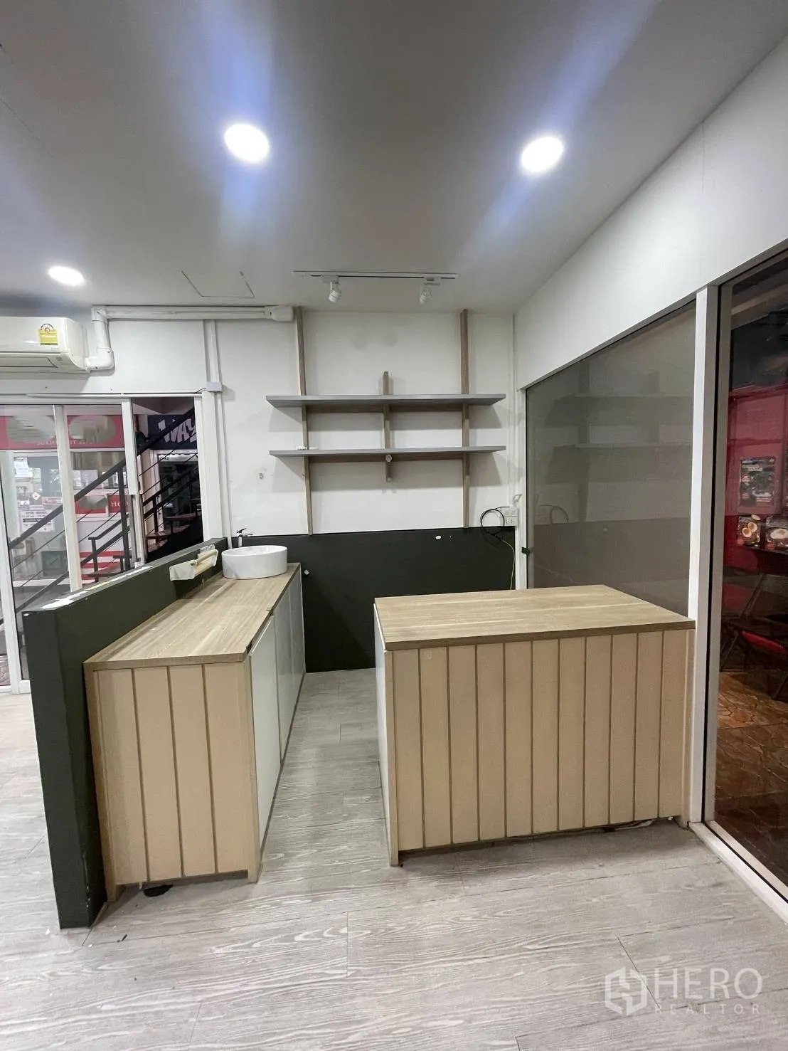 零售空间 出租在Khlong Toei, Bangkok - 店内浅木色收银台与内置展示搁架。