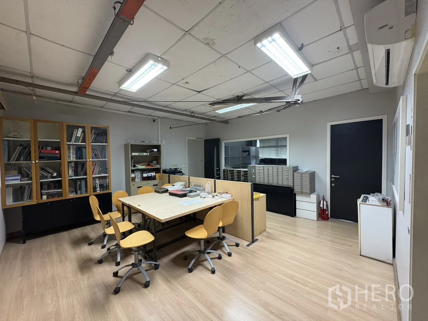 Factory for sale in Khlong Toei, Bangkok - Design office with sample cabinets and a central worktable