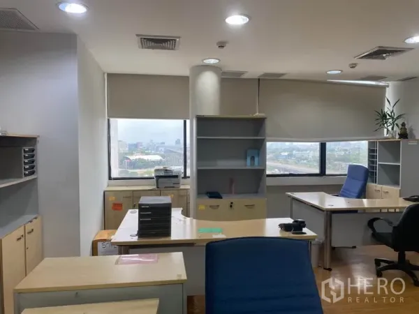 Office Space for rent in Lak Si, Bangkok - Corner workspace with desks, shelving and cabinets, roller blinds and city view windows.