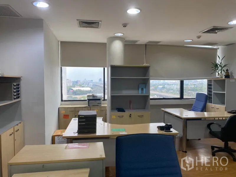 Office Space for rent in Lak Si, Bangkok - Corner workspace with desks, shelving and cabinets, roller blinds and city view windows.
