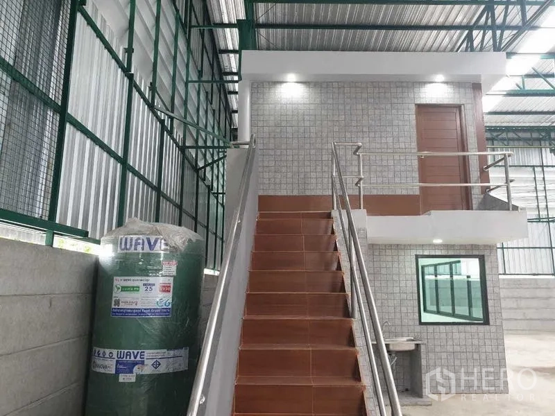 Warehouse for rent in Prawet, Bangkok - Staircase leading to the upper-floor office within the warehouse.