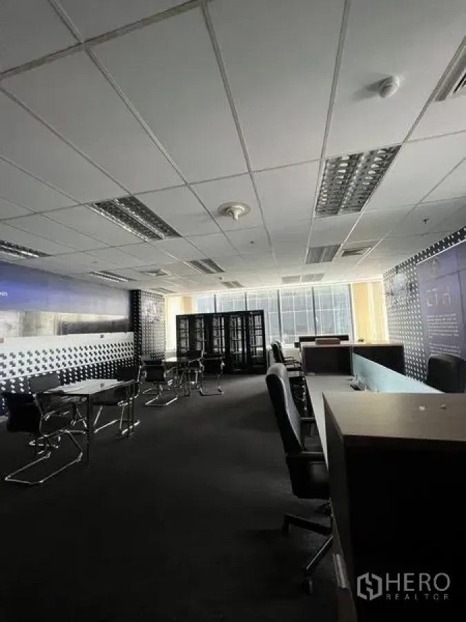Office Space for rent in Huai Khwang, Bangkok - Open office area with workstations, filing cabinets and floor‑to‑ceiling windows.