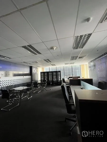 Office Space for rent in Huai Khwang, Bangkok - Open office area with workstations, filing cabinets and floor‑to‑ceiling windows.