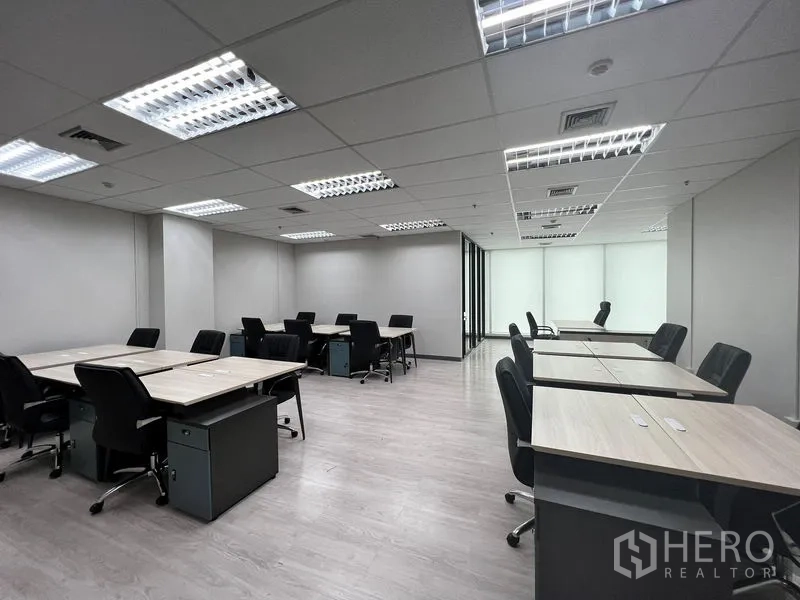 Office Space for rent in Sathon, Bangkok - Bright open workspace with large frosted windows and grouped desks.
