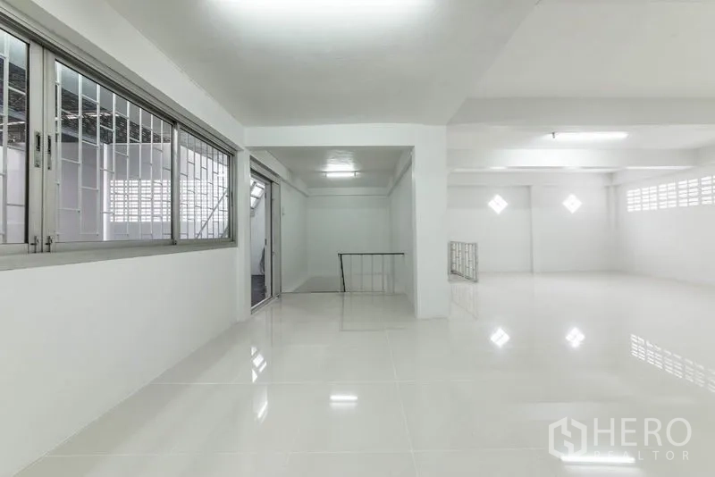 Home Office for sale in Bang Kho Laem, Bangkok - Open workspace with sliding glass, windowed partition and polished white tiles.