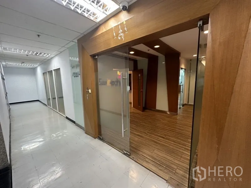 Office Space for rent or sale - Office entrance with wood-trimmed glass door from building corridor.