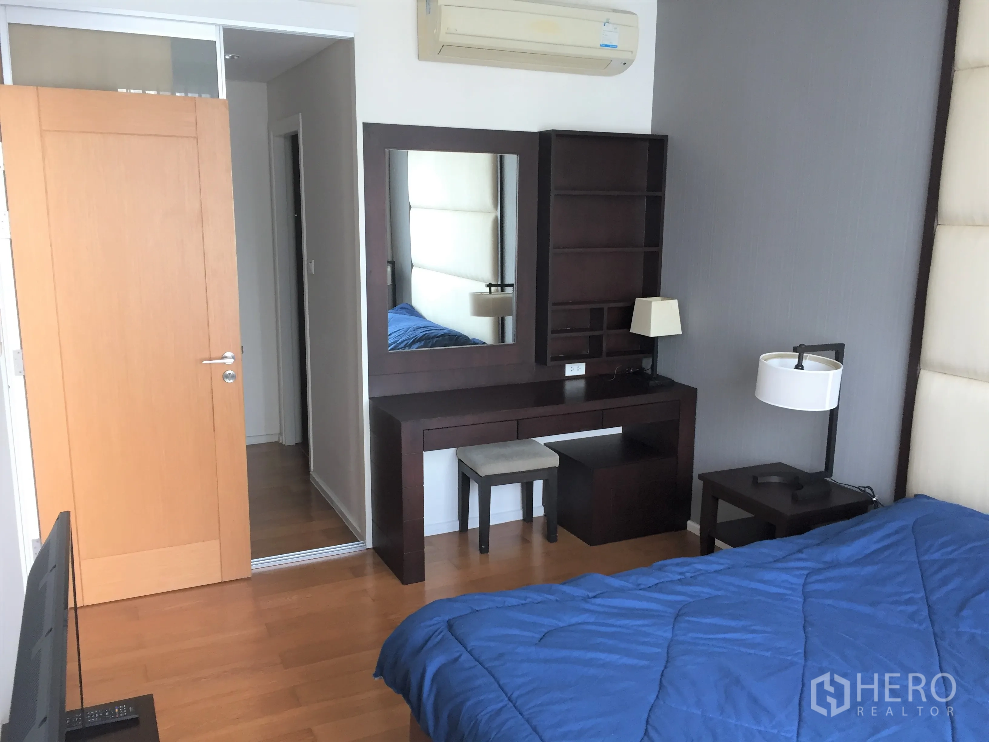 คอนโด ให้เช่าหรือขายในWatthana, Bangkok - ห้องนอนสว่าง พร้อมหัวเตียงบุนวม โต๊ะทำงาน เครื่องปรับอากาศ และพื้นไม้