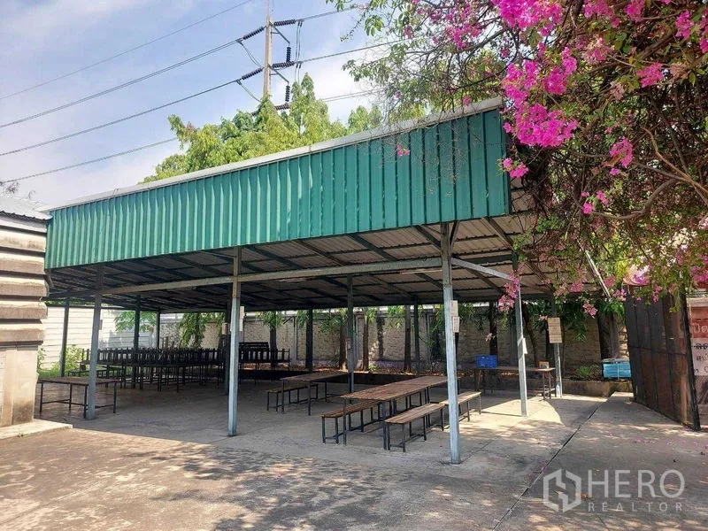 Warehouse for rent in Min Buri, Bangkok - Covered outdoor pavilion with metal roof and benches, ideal for staff canteen or break area.