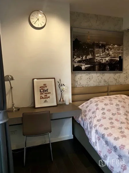 Condominium for rent in Sathon, Bangkok - Workstation corner with wall clock, desk lamp and framed art.