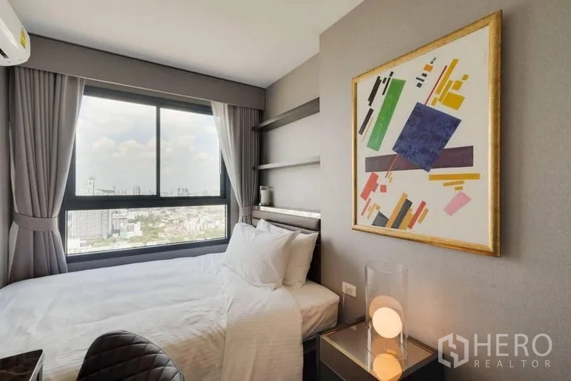 Condominium for rent in Phra Khanong, Bangkok - Second bedroom with large window and city skyline view in Phra Khanong.