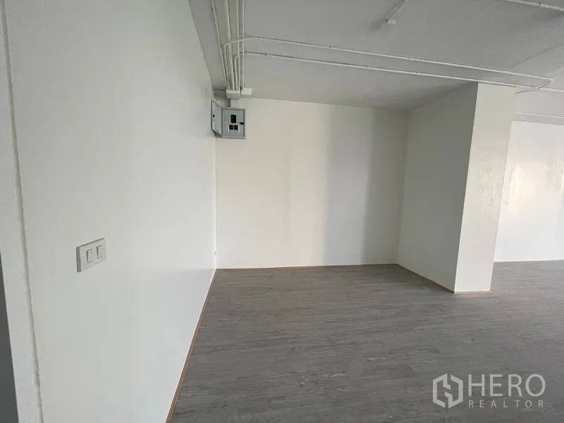 Office Space for rent in Bang Rak, Bangkok - Close-up of power box and column inside an unfurnished office space.
