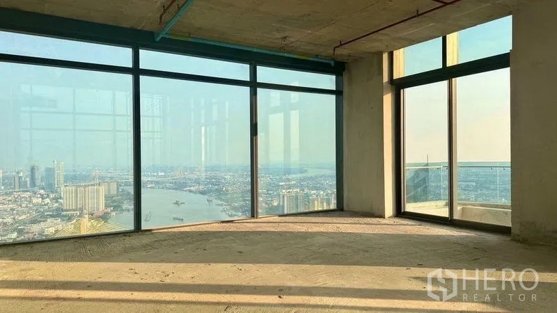 Condominium for sale in Bangkok - High-floor shell room with wraparound windows and open river view.