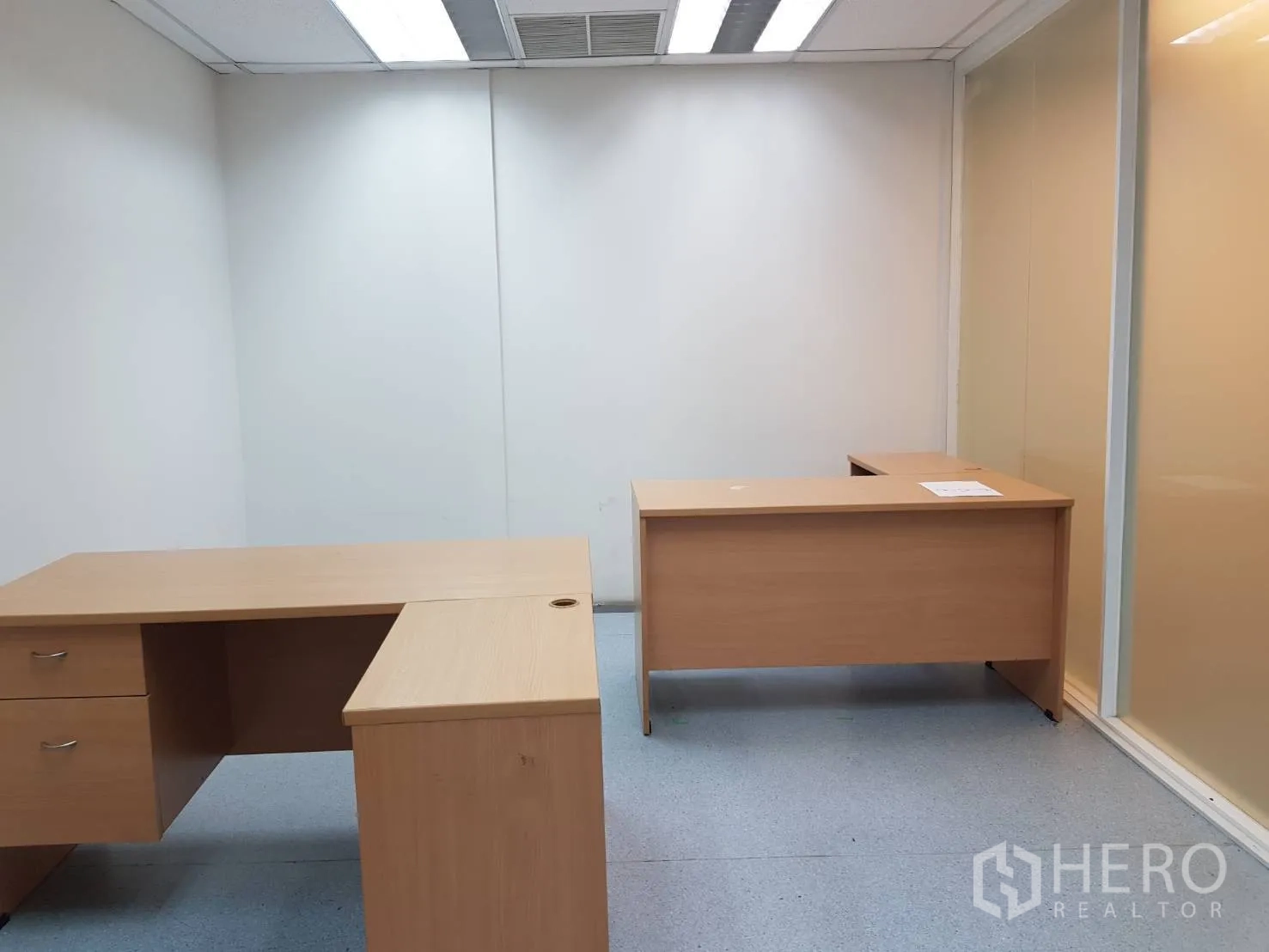 Office Space for rent in Bang Na, Bangkok - Private office featuring two L-shaped desks, frosted glass partition, and recessed lighting.