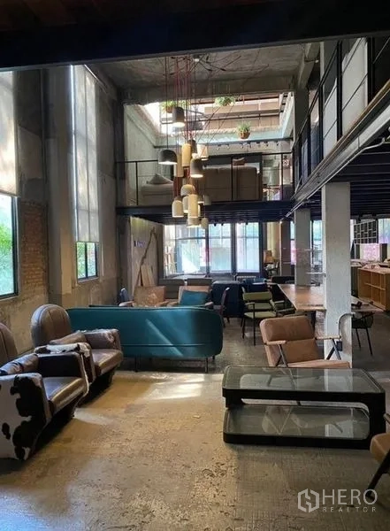 Retail Space for rent in Bang Na, Bangkok - Atrium view toward the mezzanine with cluster lights and a teal sofa