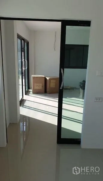 Factory for rent in Lam Luk Ka, Pathum Thani - Bright office corridor with sliding glass door and glossy tiled flooring.