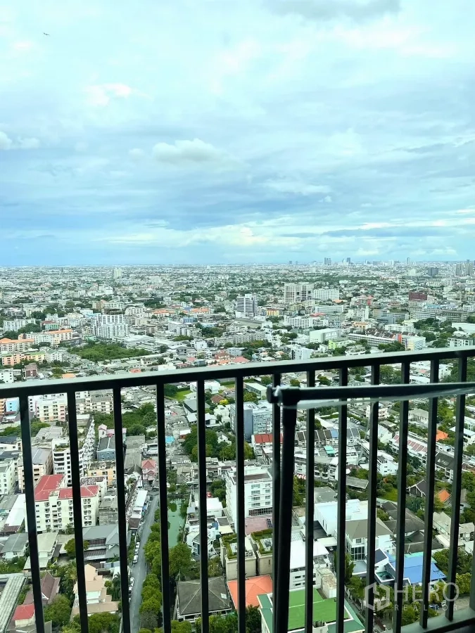 Condominium for rent in Watthana, Bangkok - Balcony railing overlooking an expansive Bangkok cityscape.