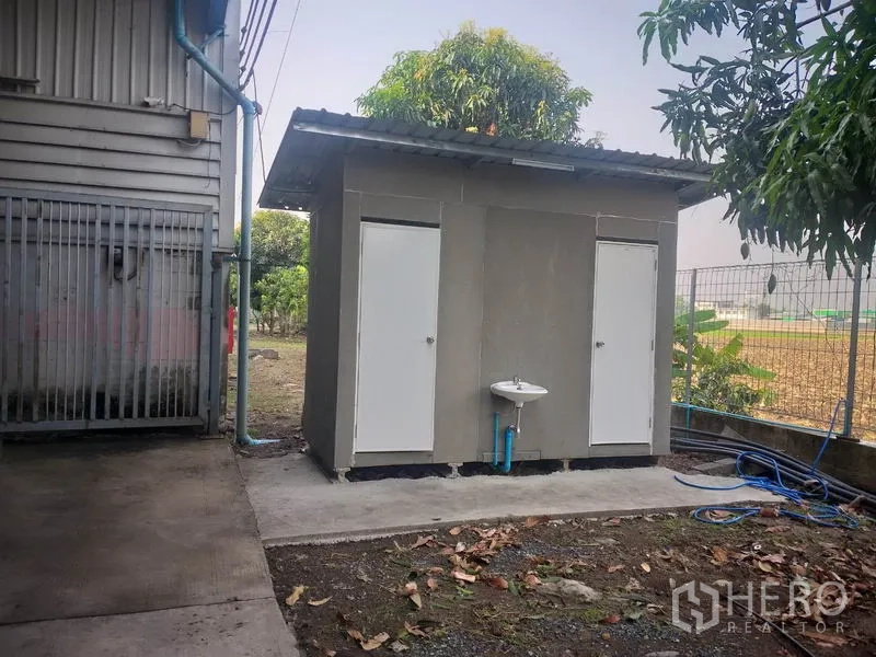 Warehouse for rent in Pathum Thani - Separate outdoor restroom block beside the warehouse with a sink.