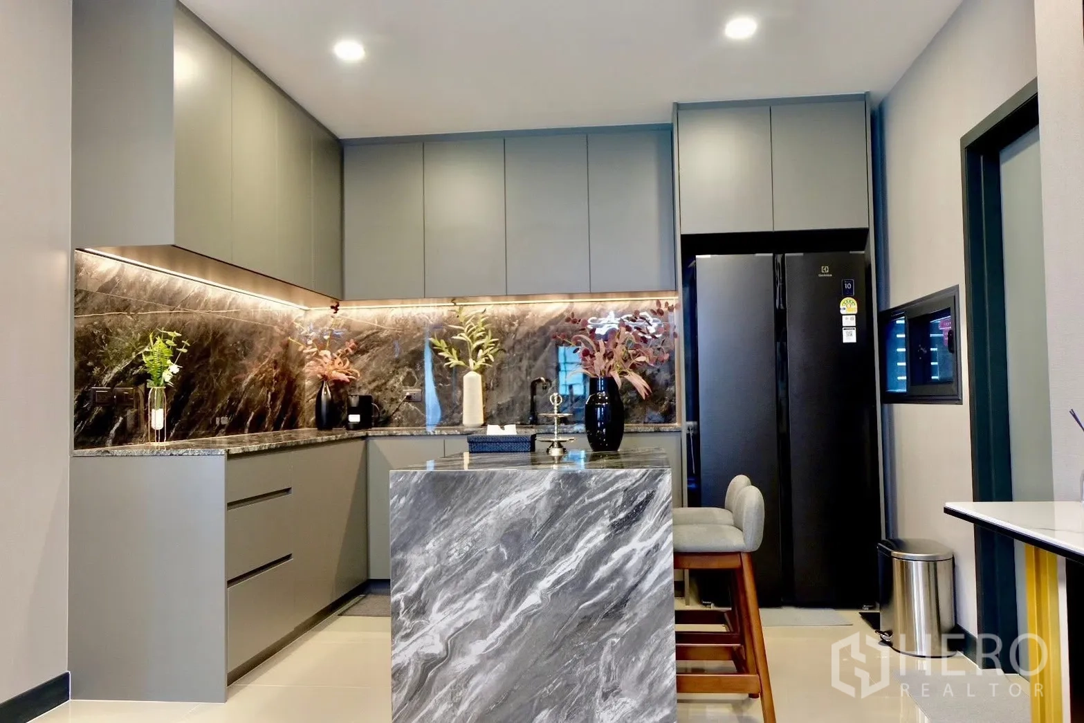 Semi-detached House for sale in Prawet, Bangkok - Bright kitchen with island, overhead cabinets and recessed lighting.