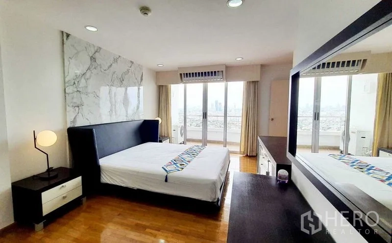 Condominium for sale in Bang Kho Laem, Bangkok - Primary bedroom opening to a balcony with panoramic city skyline view.