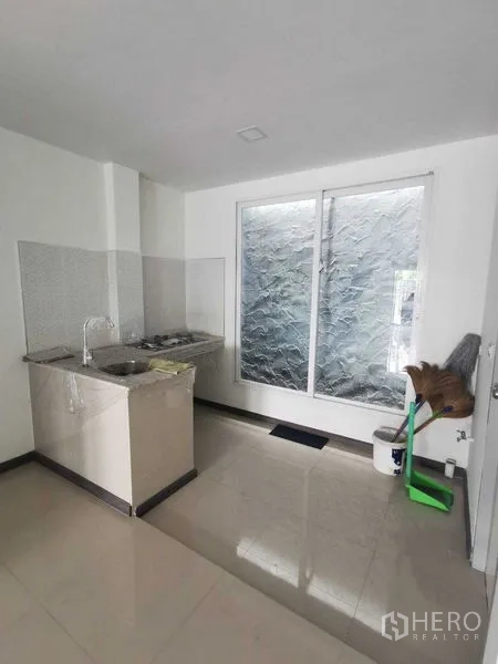 Home Office for rent or sale - Pantry kitchenette with sink, hob, and frosted sliding window.