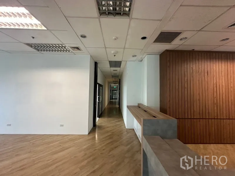 Office Space for rent in Ratchathewi, Bangkok - Reception area leading to a corridor, wood slat feature wall and built-in counter in a modern office.