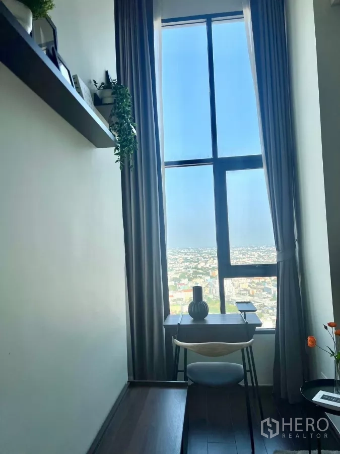 Condominium for rent in Watthana, Bangkok - Small study desk positioned at a window with city views.