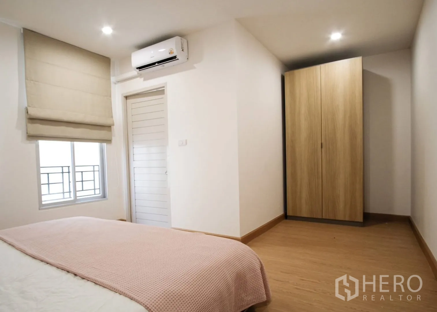 Townhouse for rent in Bang Phli, Samut Prakan - Cozy bedroom with air conditioner, window blinds, and a wooden wardrobe.